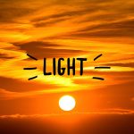 Sunset with the word "Light" with rays extending from the right and left sides of the word.